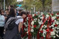 Young student sniffing the flowers of the floral wreaths placed for Tirana's Liberation Day.